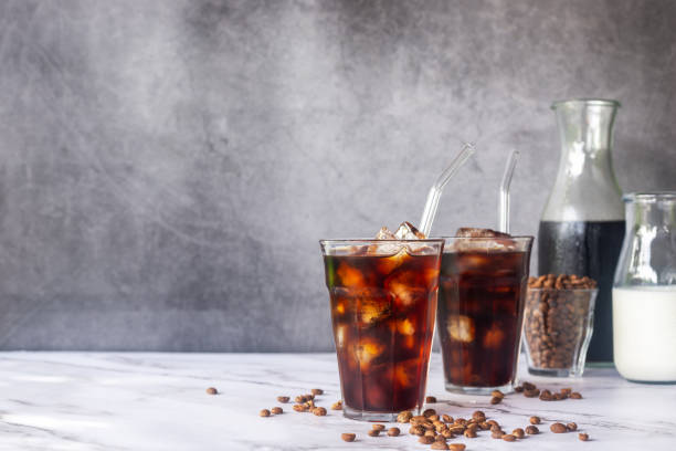 istock iced homemade cold brew coffee  with glass straw on white marble  table. 2168532333