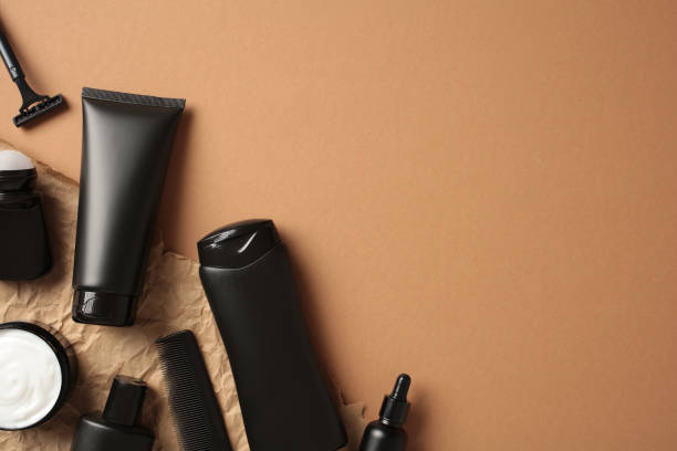 istock Bathroom shampoo bottles with cream and deodorant on brown background. 2168535105