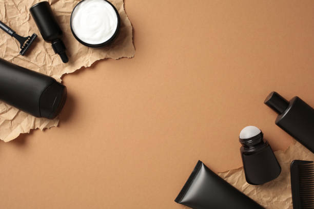 istock Black cosmetic bottles on kraft paper on brown background. Flat lay, top view. 2168535408