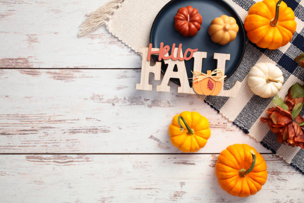 istock Cozy home desk table with checkered tablecloth, pumpkins, sign fall, flowers on rustic wooden background. 2168536189
