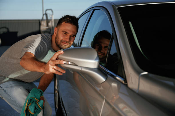 istock Looking at the side mirror, cleared. Man is with his car outdoors 2168536190