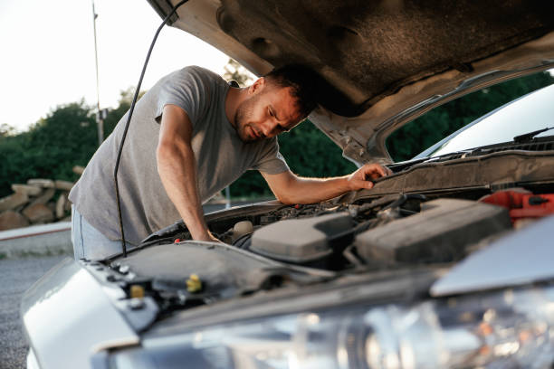 istock Problem, fixing and repairing the broken automobile. Man is with his car outdoors 2168536436