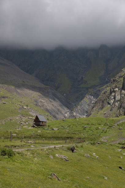 istock green mountains and rainy clouds 2168541756