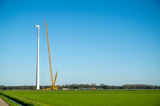 Wind turbine construction with huge cranes at a new wind park in Flevoland, Netherlands.