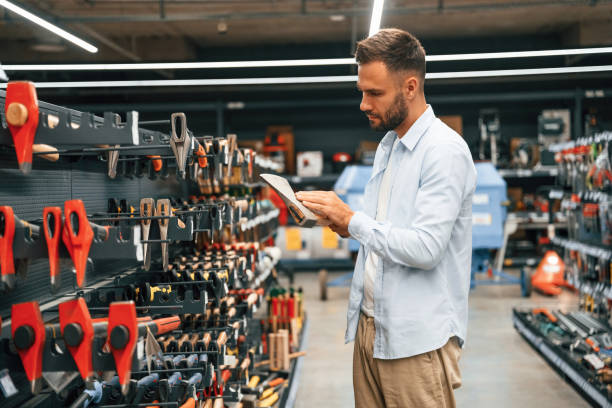 istock Picking an axe. Man is in the hardware shop 2168543441