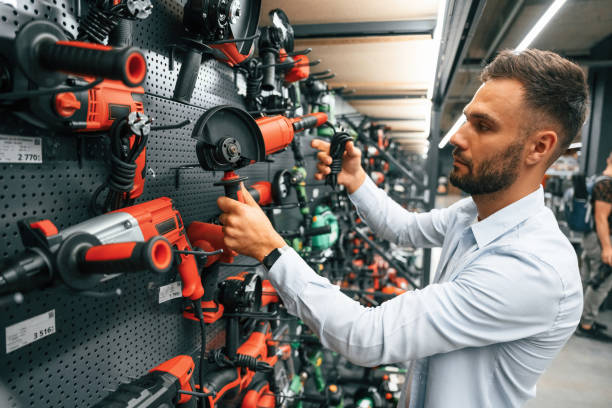 istock Selecting the new equipment. Man is in the hardware shop 2168543576
