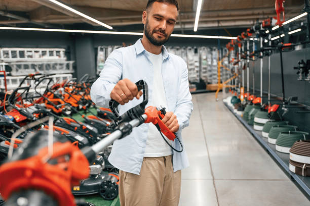 istock Grass trimmer in hands. Man is in the hardware shop 2168543670