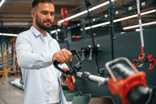 istock Grass trimmer in hands. Man is in the hardware shop 2168543681