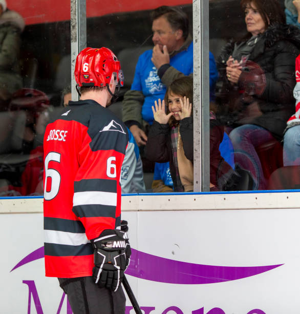 istock Joyful Interaction Between Young Fan and Hockey Player 2168543957