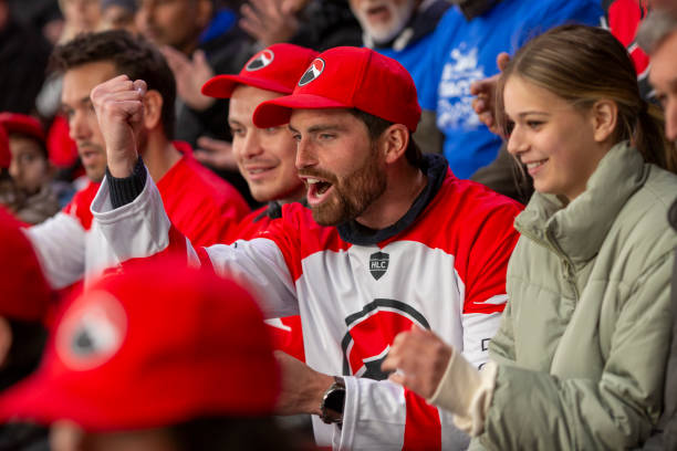 istock Passionate Fans Cheering for Their Hockey Team 2168544544