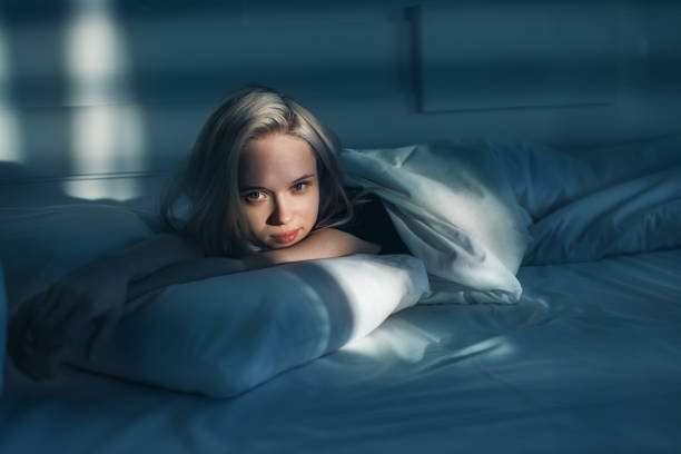 istock Blonde woman lying on bed. 2168545974