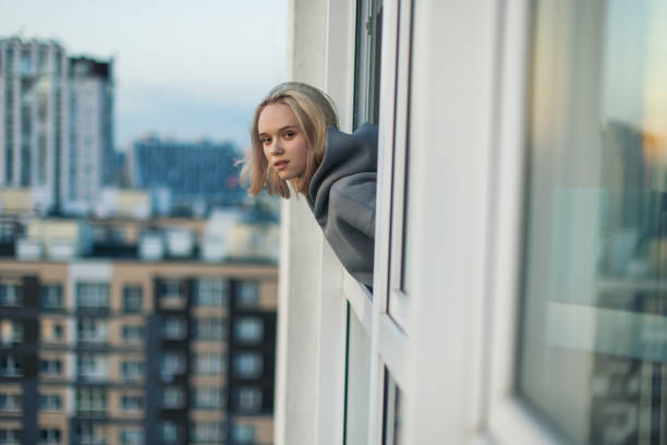 Young blonde woman on balcony.