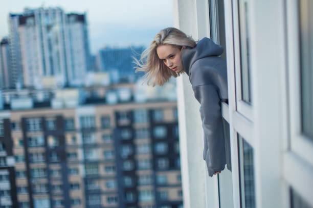 Young blonde woman on balcony.
