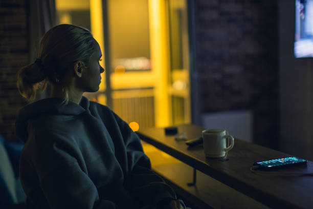 istock Young blonde woman watching tv. 2168546281