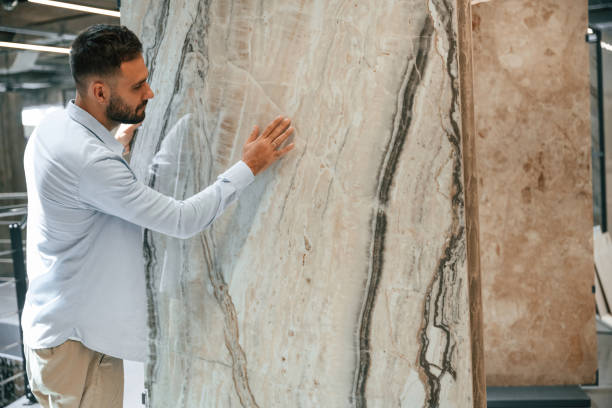istock Huge tile, for floor or wall. Man is in the hardware shop 2168546377