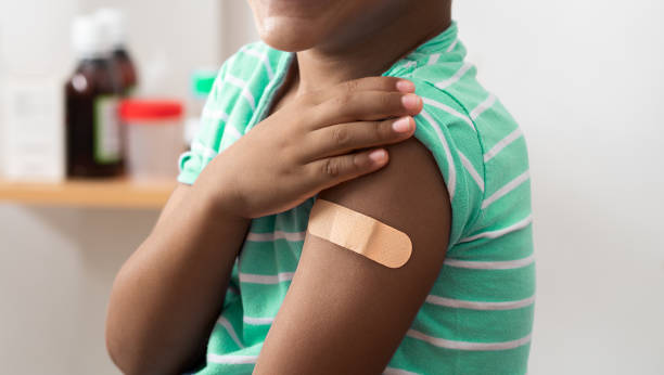 istock black child with band aid on his arm after vaccination 2168547392