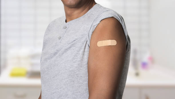 istock black man with band aid on arm after vaccination 2168547457