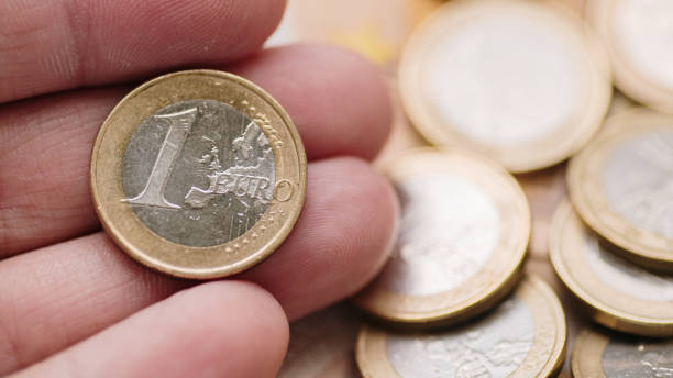 istock Hand holding a 1 euro coin 2168551272