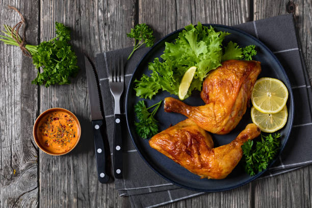 istock fried chicken legs with lettuce, lemon on plate 2168551328