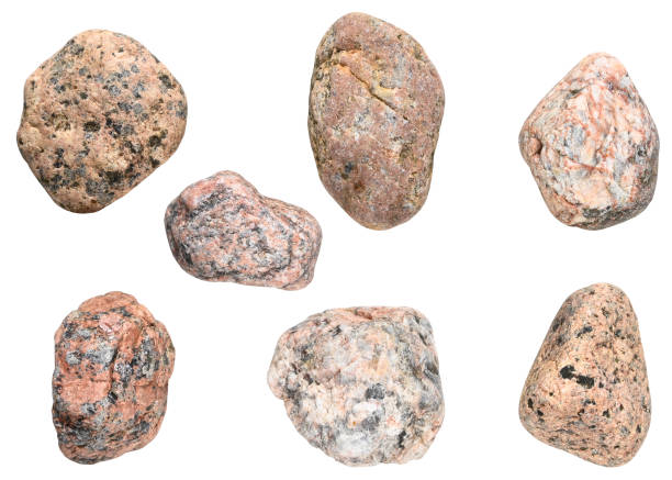 Set granite sea pebble stones isolated on a white background. Top view.