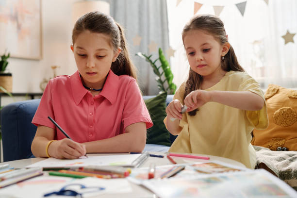 istock Two Young Girls Engaging in Creative Drawing Activity 2168556227