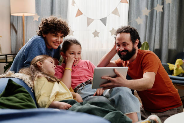 istock Family Enjoying Time Together Watching Tablet Device 2168556295