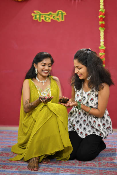 istock Bride with her younger sister during the Mehandi ceremony 2168558148