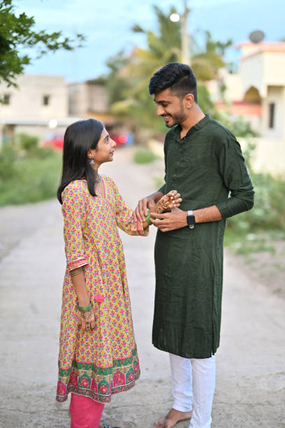 istock Siblings in traditional attire engaged in casual conversation 2168558963