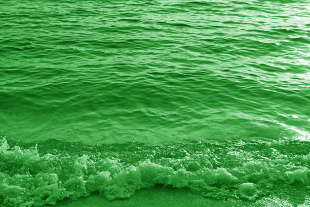 Pop art surreal style green colored splashing waves and sea ripples
