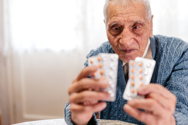 istock Elderly Man Holding Pills In His Hands 2168563917