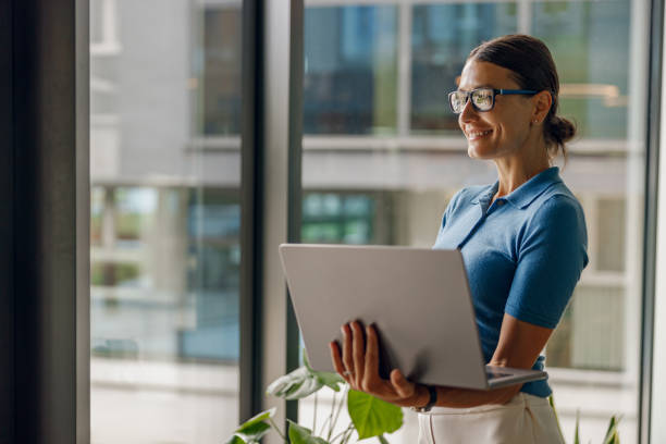 istock A modern professional woman is diligently working with her laptop in a bright, open office space 2168565260