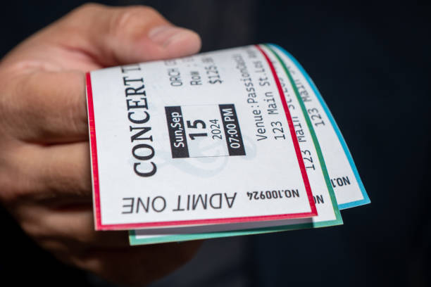 A man is engaged in ticket scalping, selling concert tickets at a significantly higher price than face value