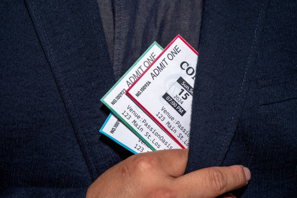 istock A hand extracts three concert tickets from a pocket, a common tactic used in ticket scalping 2168567773