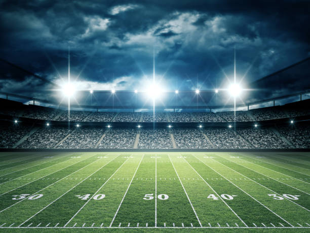 istock IlIuminated American Football Stadium at night with empty field. 2168568795