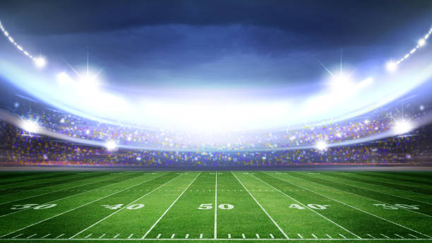 istock IlIuminated American Football Stadium at night with empty field. 2168569628
