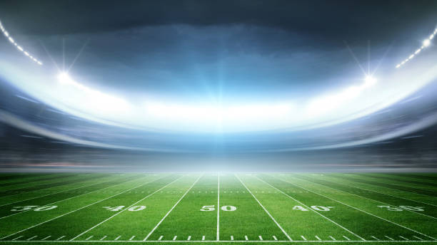 istock lIIuminated American Football Stadium at night with empty field. 2168570127