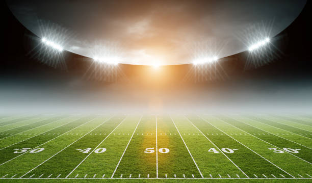 istock IIIuminated American Football Stadium at night with empty field. 2168570529