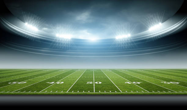 istock IIIuminated American Football Stadium at night with empty field. 2168570732