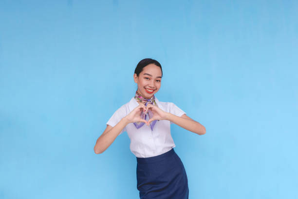 istock A flight attendant showing affection and love by doing the heart sign. Stewardess with her hands curled towards each other. 2168571806