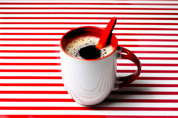 Coffee mug with striped background in red and white colors, vibrant image