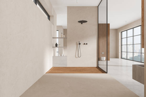 istock Beige home bathroom interior with glass shower and panoramic window 2168579930