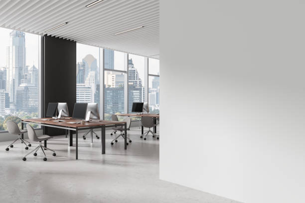 istock Coworking interior with table and pc monitors, window. Mockup wall 2168582319