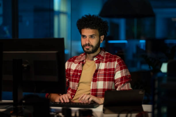 istock Young businessman working late in office 2168582689