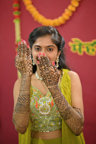 istock Bride in her modern traditional attire displaying her Mehandi 2168583814