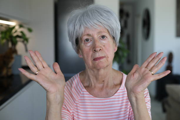 Very critical looking senior woman with a disapproving expression A cute and very critical looking Caucasian senior woman in her late sixties is looking at camera with a disapproving expression. woman stealth stock pictures, royalty-free photos & images