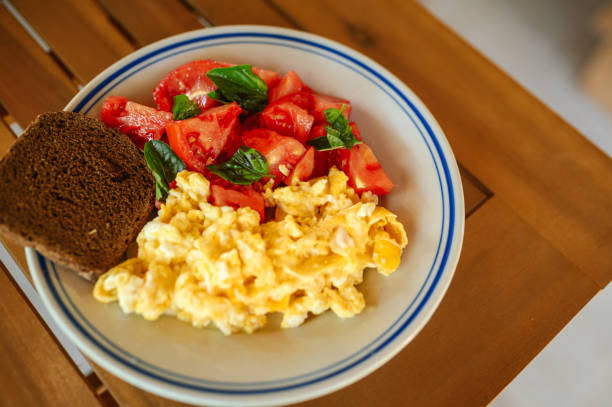 Homemade Scrambled eggs and fresh tomato salad - delicious morning breakfast