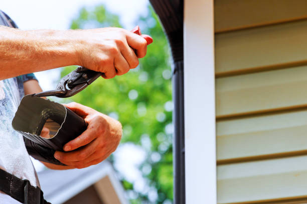 istock Preparation aluminum rain gutters before of cutting by a worker using metal shears 2168588606