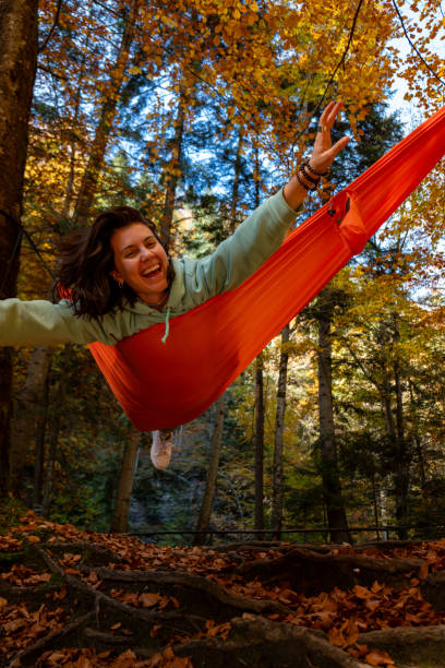 istock Relaxing in a Hammock in Autumn Forest 2168588948
