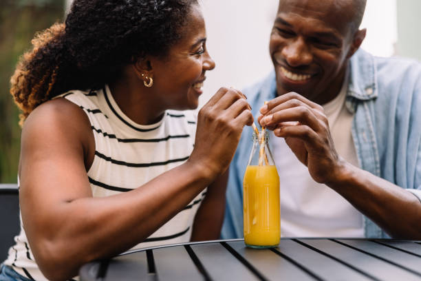 istock Joyful black couple smiling and having fun with a drink 2168590514