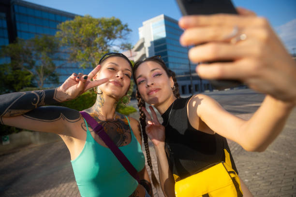 istock Two young happy women looking smartphone outdoor 2168592183